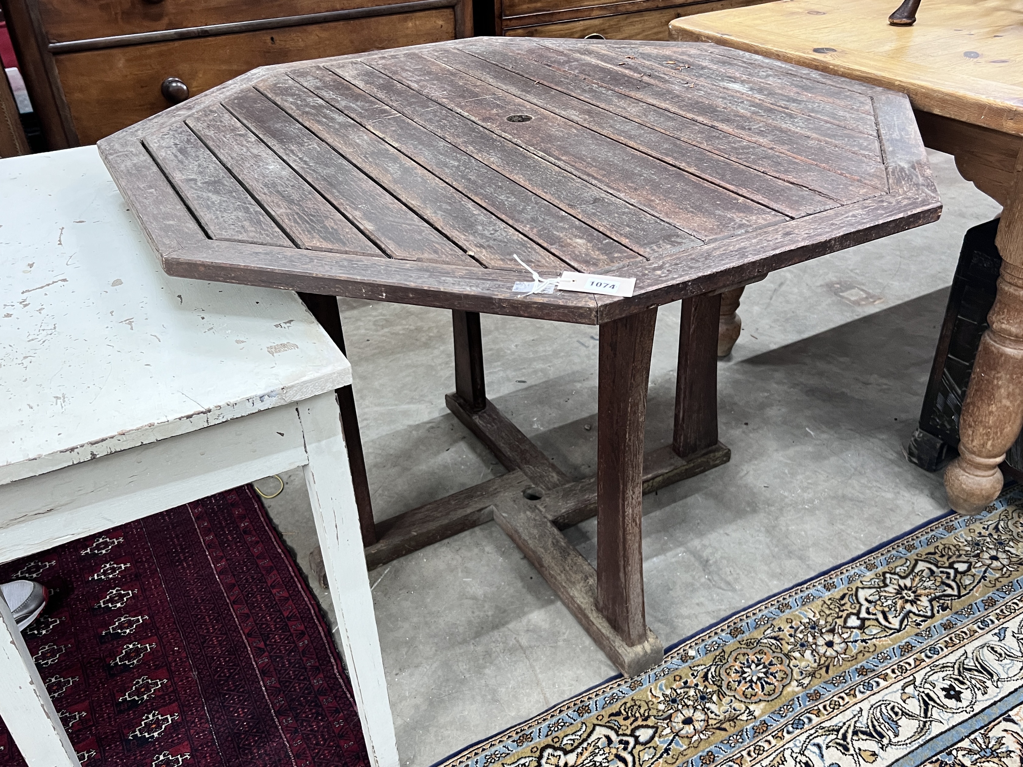 An octagonal teak garden table, width 111cm, height 75cm